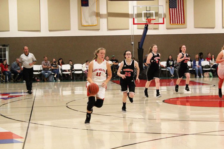HCAHighSchoolGirlsdirbbletheballbackdownthecourtandscoreagainstVictoryChristian Athletics at Haywood Christian Academy